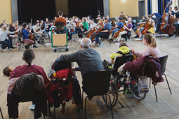 Zuschauer im Rollstuhl bei einer Orchesterprobe